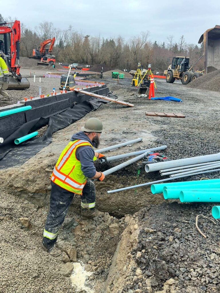 Tech working on active construction site bending conduit.