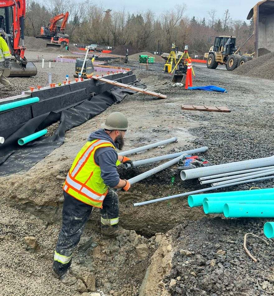 Tech working on active construction site bending conduit.